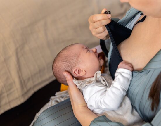 mother breastfeeds newborn baby motherhood child care concept