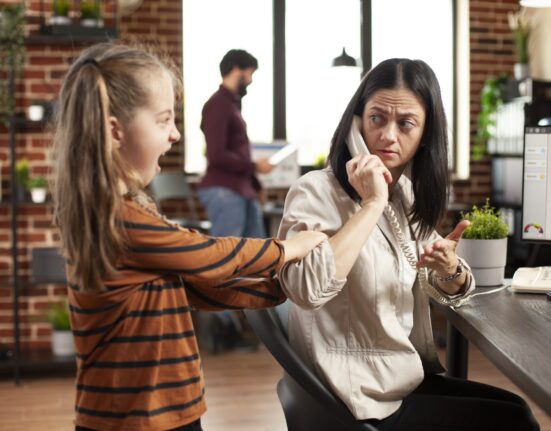 female child distracts mother office