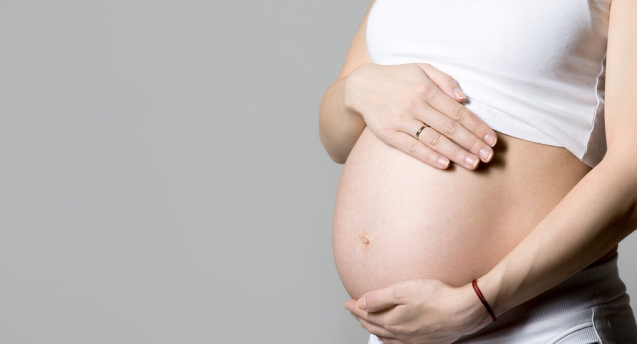 pregnant woman touching her belly