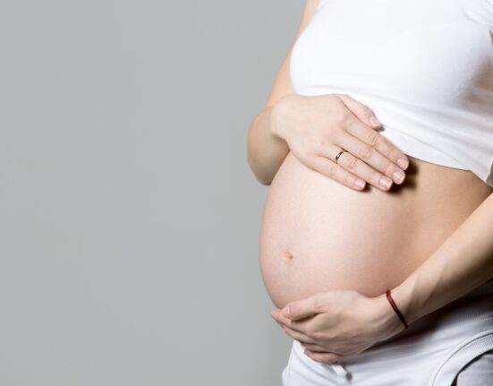 pregnant woman touching her belly